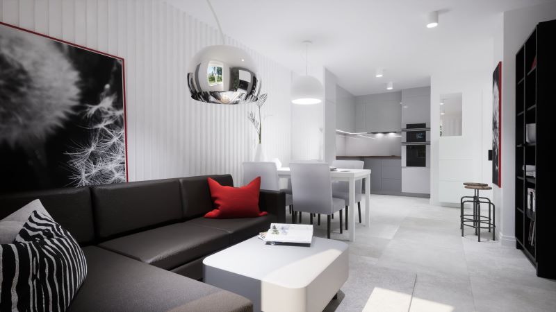 czarna-sofa-w-jasnym-salonie-czerwone-akcenty